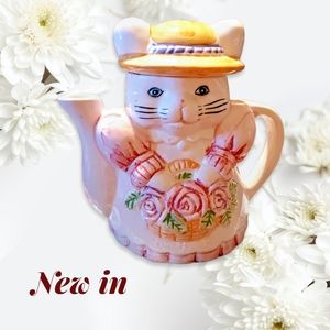 Vintage Cat Shaped Teapot Holding a Basket of Pink Roses